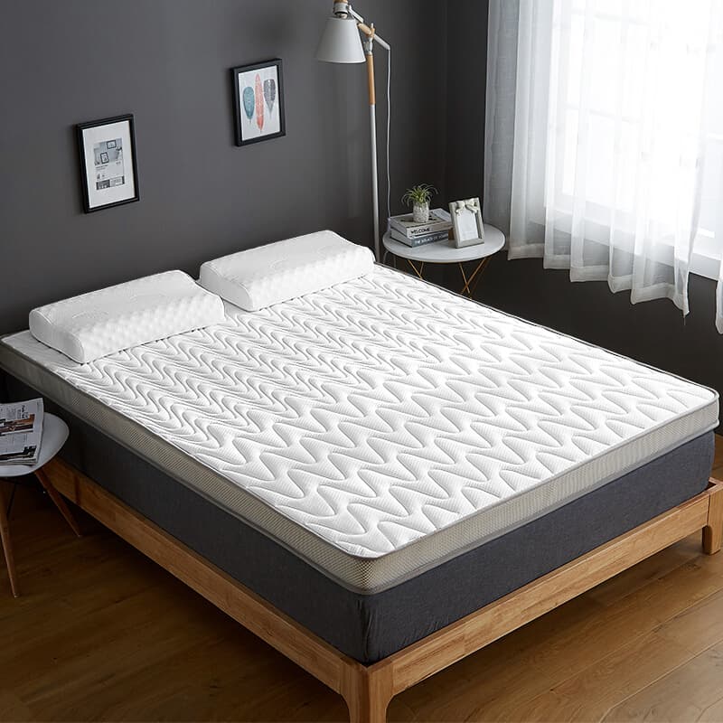 Mattress in a calm bedroom, white sculpted top suggesting slow contouring foam.