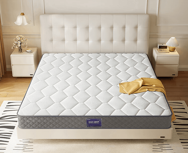 Tufted mattress on a platform frame in a bright bedroom—thick comfort stack over a supportive base.